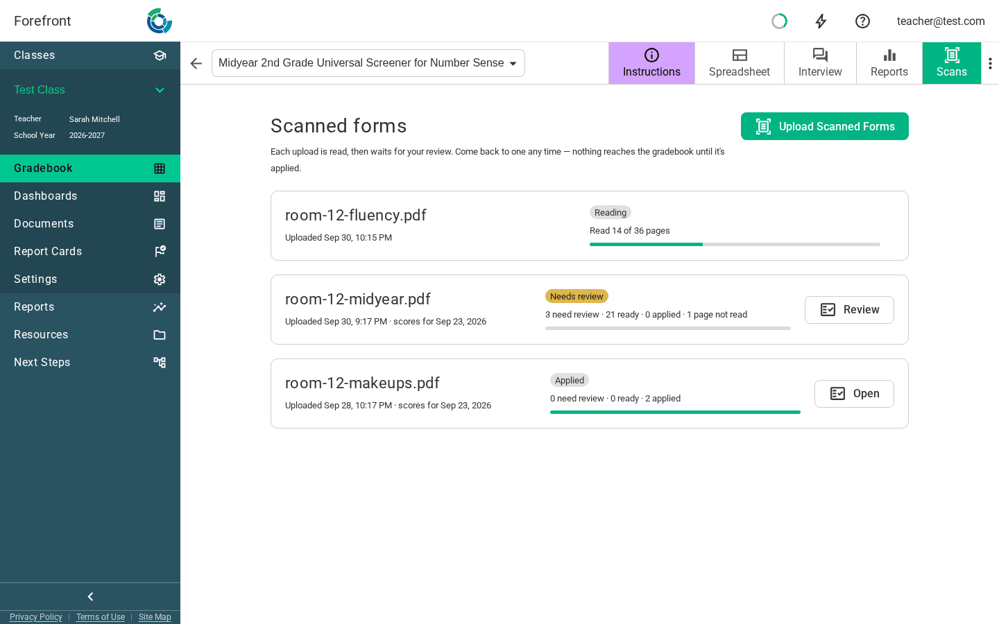The gradebook's Scans page: an upload still reading, one waiting on review, and one applied